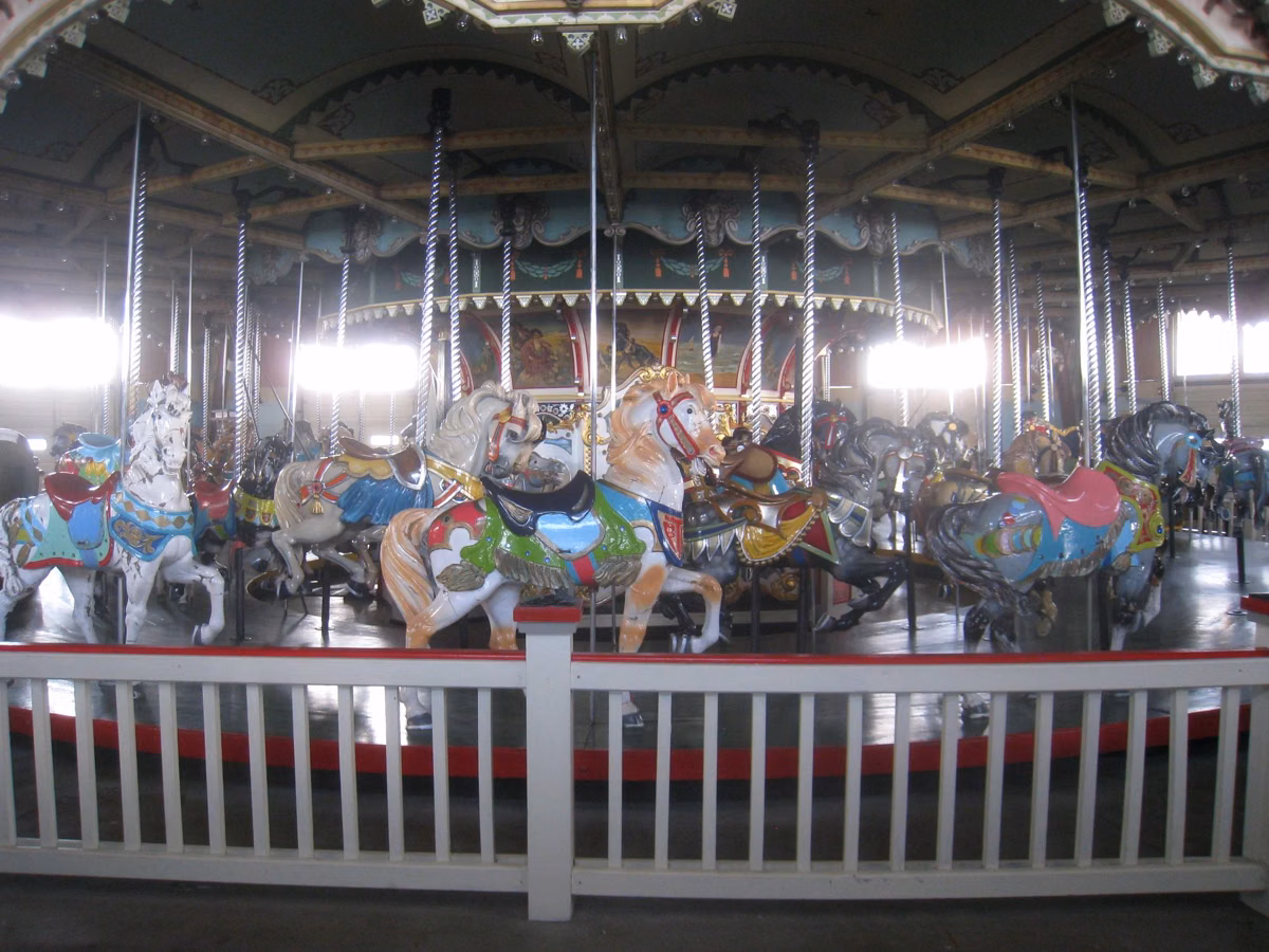 Painted wooden horses inside the historic Paragon Carousel in Hull